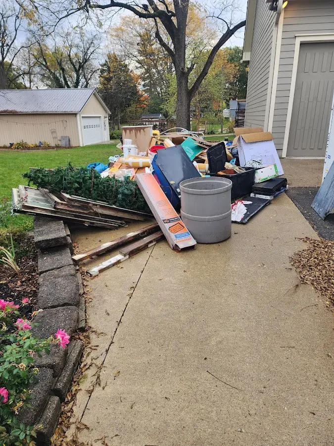 Dumpster being loaded with debris for 12 Yard Dumpster Rental in Lincoln Heights